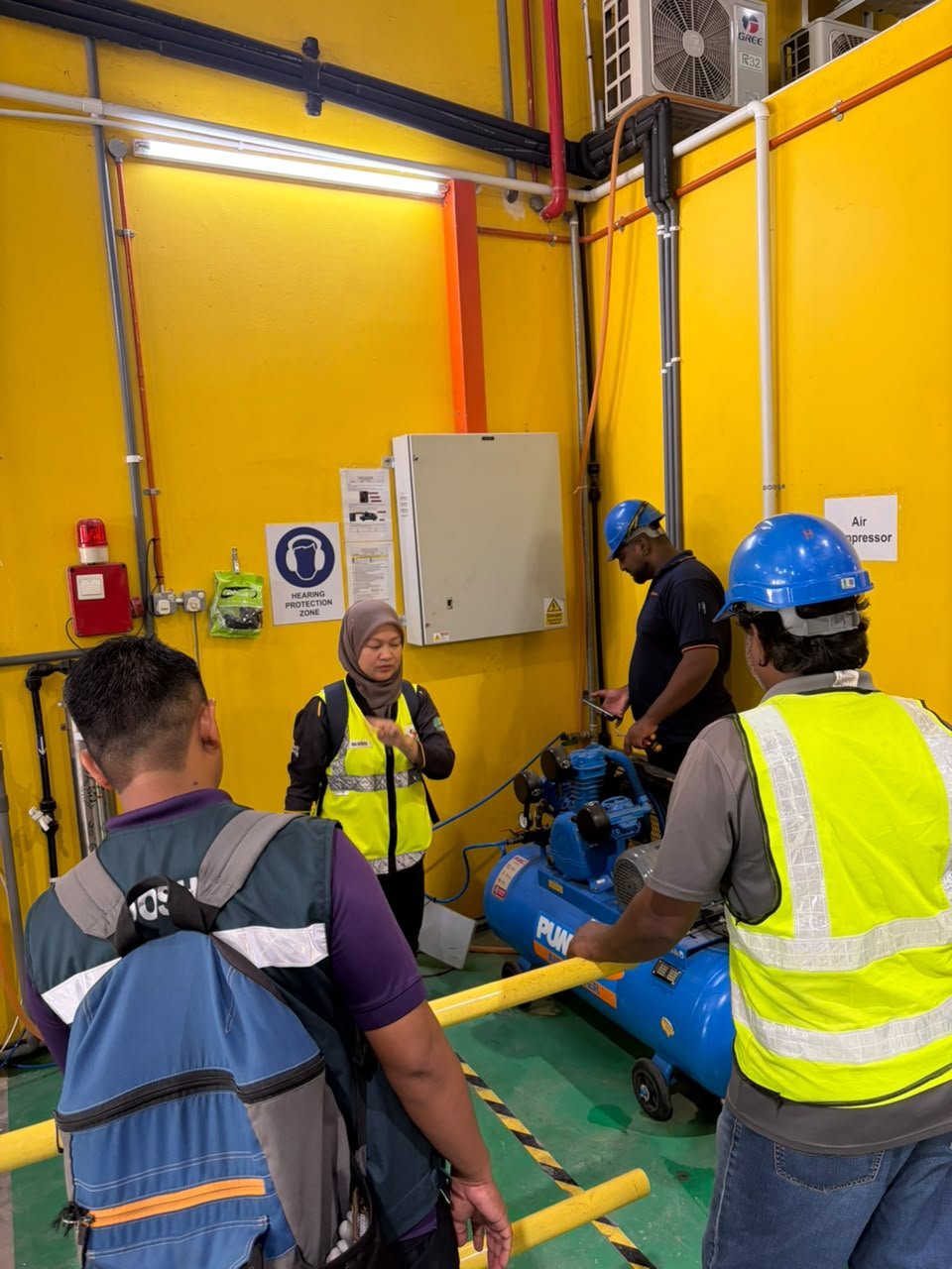 JKKP officers inspecting the air compressor room and hearing protection zone at ORIZI Group