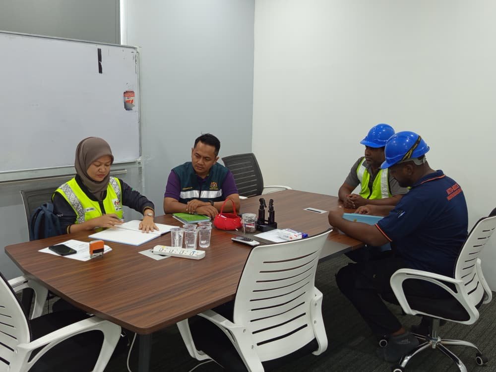 JKKP officers reviewing safety documentation with ORIZI Group team during the workplace OSH inspection