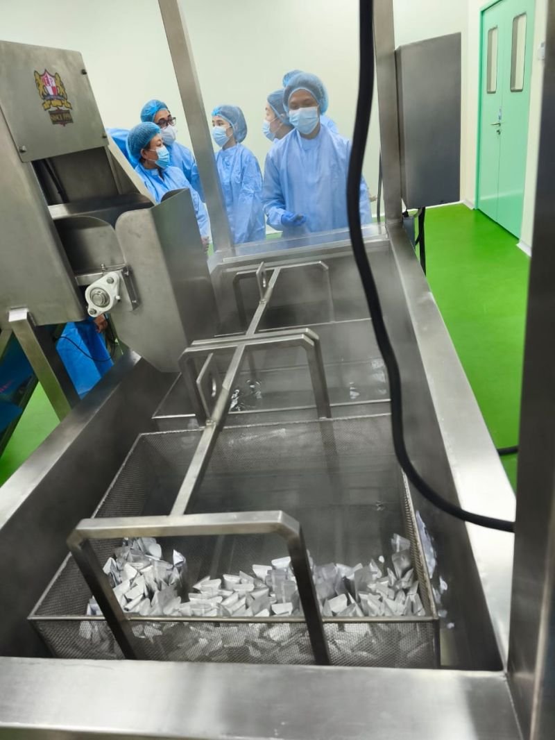 Filled foil sachets in a stainless steel processing basket on the Nutrizens sachet line