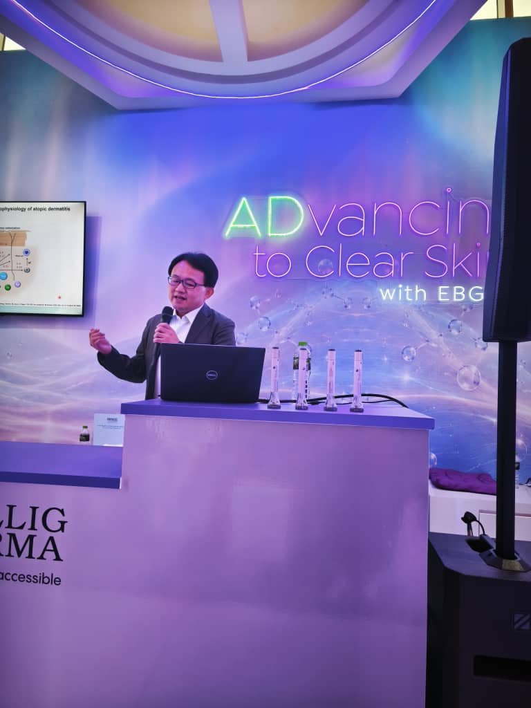 Speaker presenting on atopic dermatitis at an industry symposium during PDM ADC 2026