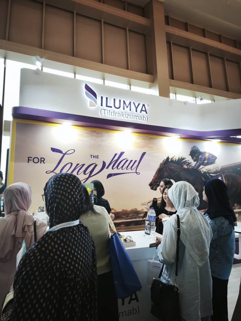 Delegates gathering at an exhibition booth during PDM ADC and AGM 2026